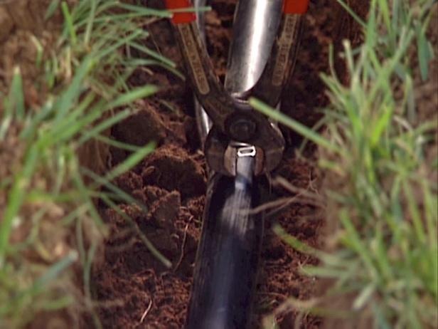 Crimping the clamp securely over the pipe